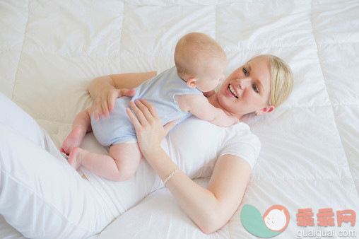 白色,人,床,2到5个月,四分之三身长_565882281_Caucasian mother cuddling baby on bed_创意图片_Getty Images China