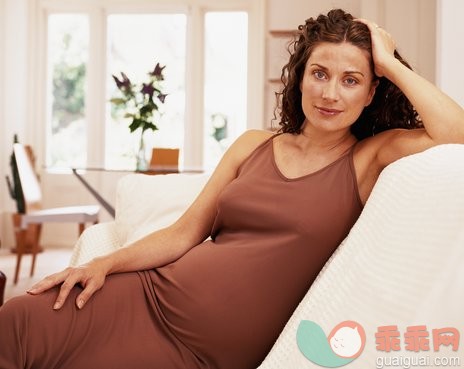 家庭生活,摄影,肖像,室内,人_AA043656_Pregnant woman sitting on couch, portrait_创意图片_Getty Images China