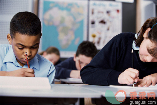 人,书桌,制服,教育,室内_78575992_Portrait of students at work during class_创意图片_Getty Images China