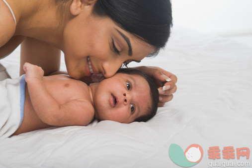 人,床,四分之三身长,室内,20到24岁_140833737_Woman playing with her baby_创意图片_Getty Images China