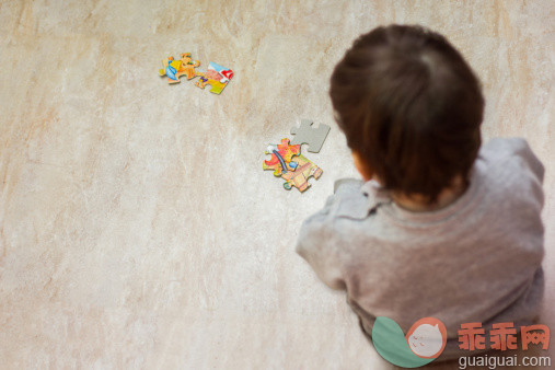 人,婴儿服装,12到17个月,室内,谜题游戏_486067761_Toddler girl looking at pieces of jigsaw puzzle_创意图片_Getty Images China