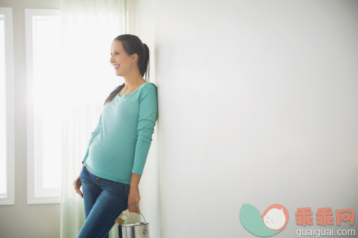 人,休闲装,人生大事,生活方式,四分之三身长_478160365_Pregnant woman with paint can leaning against bare wall_创意图片_Getty Images China