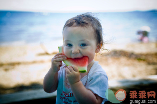 人,休闲装,T恤,饮食,户外_107909971_Toddler eating watermelon on beach_创意图片_Getty Images China