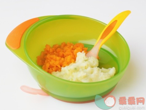 食品饮料,银餐具,饮食,影棚拍摄,碗_74422446_Carrot and potato puree served in green plastic bowl with yellow plastic spoon embedded_创意图片_Getty Images China