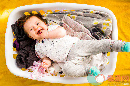 进行中,人,生活方式,2到5个月,室内_557473487_Caucasian baby girl laying in laundry basket_创意图片_Getty Images China