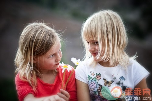 金色头发,白人,花,慷慨,给予_gic14876228_Two young girls (6-9) giving each other flowers_创意图片_Getty Images China