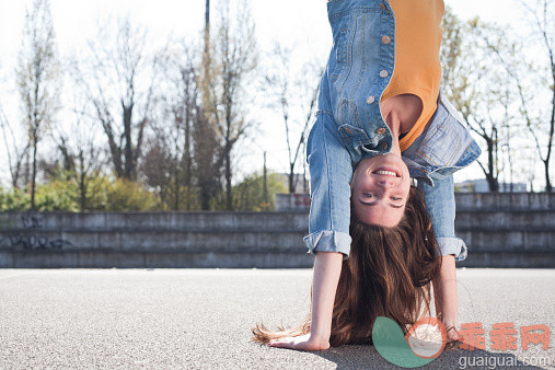 人,休闲装,户外,25岁到29岁,快乐_525467043_Young woman doing a handstand_创意图片_Getty Images China