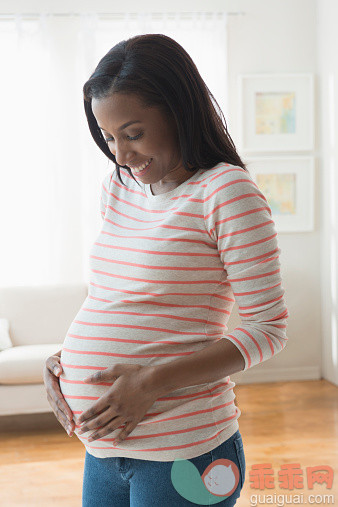 人,人生大事,四分之三身长,室内,25岁到29岁_519515999_Black woman holding her pregnant stomach_创意图片_Getty Images China