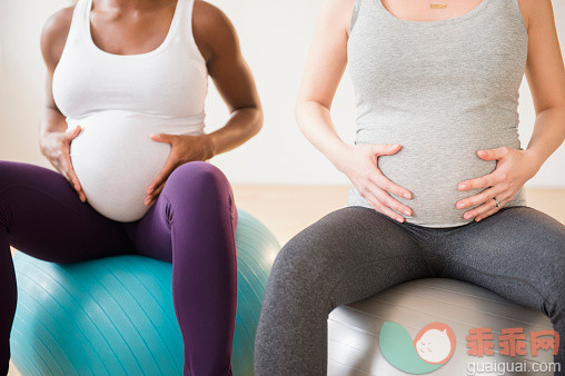 人,人生大事,生活方式,室内,中间部分_557475421_Pregnant women holding stomachs sitting on fitness balls_创意图片_Getty Images China